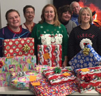 UH Staff standing with donated presents