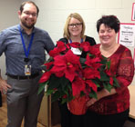 Staff receiving poinsettias from Usborne and Hibbert