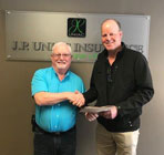 Brad Boerson shakes hands with JP Uniac Insurance